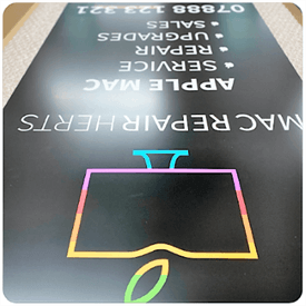 custom sign with white text and full color logo on black background